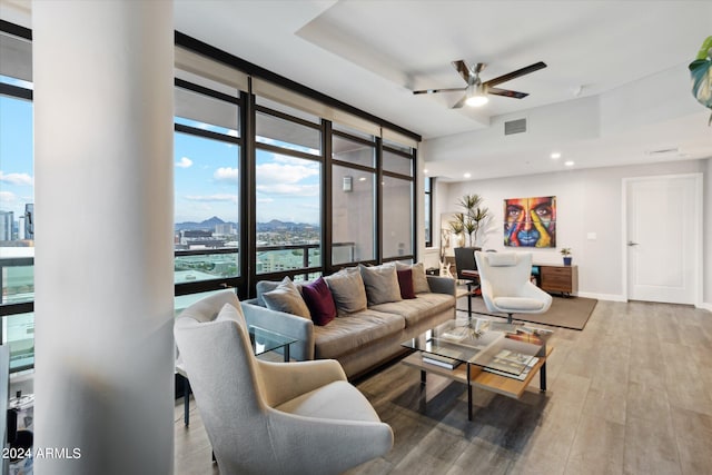 living room featuring floor to ceiling windows, ceiling fan, and hardwood / wood-style floors