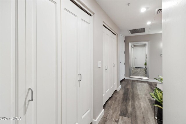 hallway with hardwood / wood-style floors