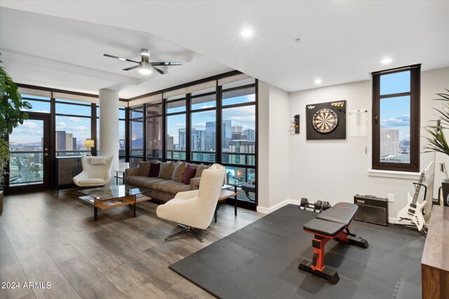 living room with wood-type flooring, french doors, expansive windows, and ceiling fan