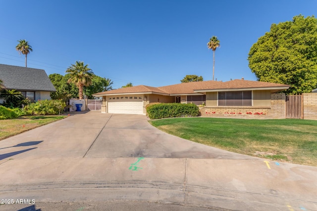 ranch-style house with a garage and a front yard