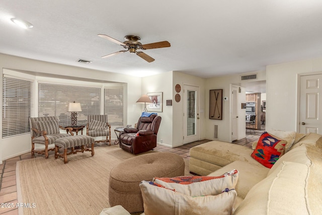 living room featuring light tile patterned flooring and ceiling fan