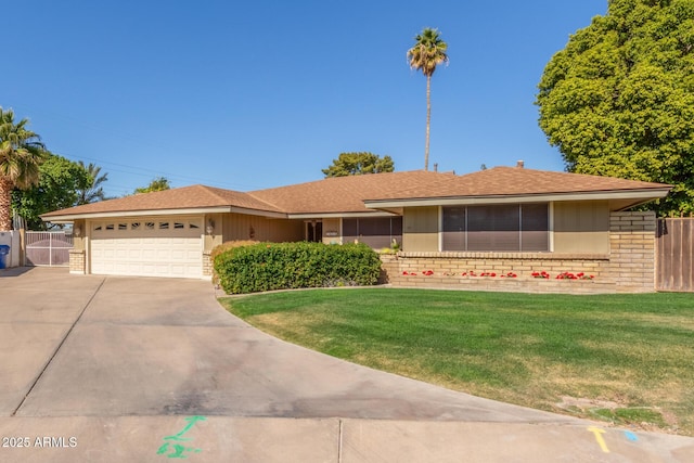 ranch-style house featuring a garage and a front yard