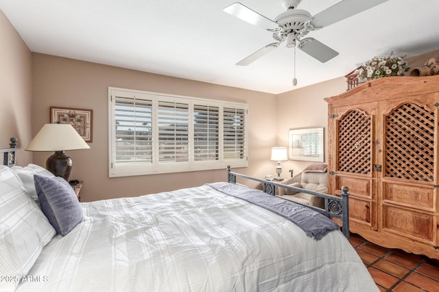 tiled bedroom featuring ceiling fan