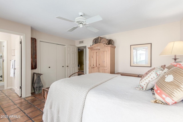 tiled bedroom featuring ceiling fan, connected bathroom, and a closet