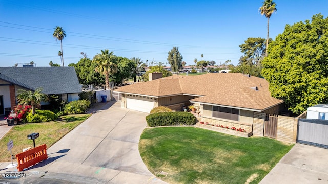 ranch-style home with a garage and a front lawn