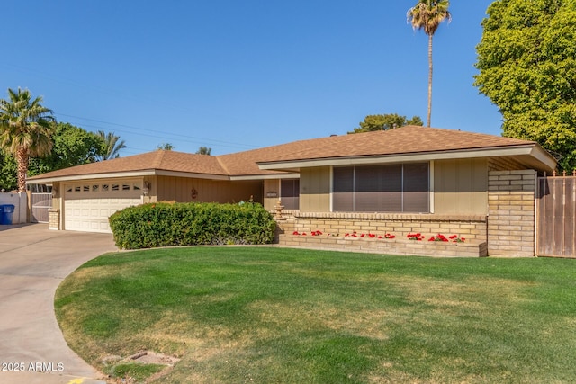 ranch-style house featuring a garage and a front lawn