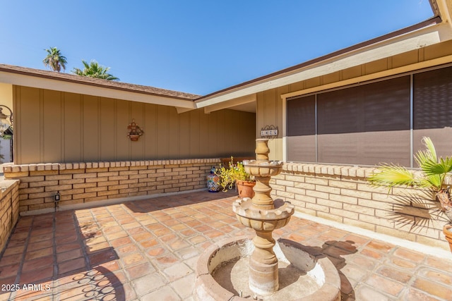 property entrance featuring a patio area