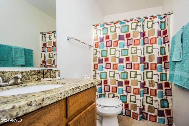 bathroom with tile patterned flooring, vanity, curtained shower, and toilet