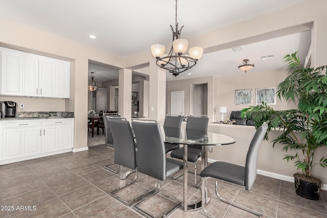 dining space featuring a notable chandelier