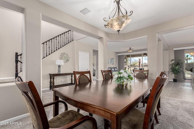 dining space featuring light carpet