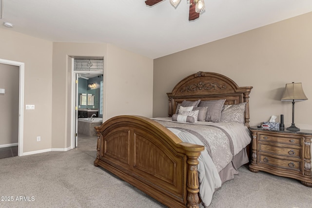 bedroom with light carpet, ensuite bath, and ceiling fan