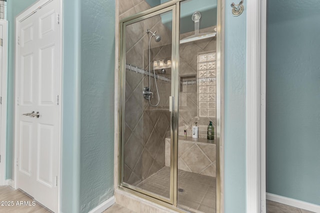 bathroom featuring tile patterned floors and an enclosed shower