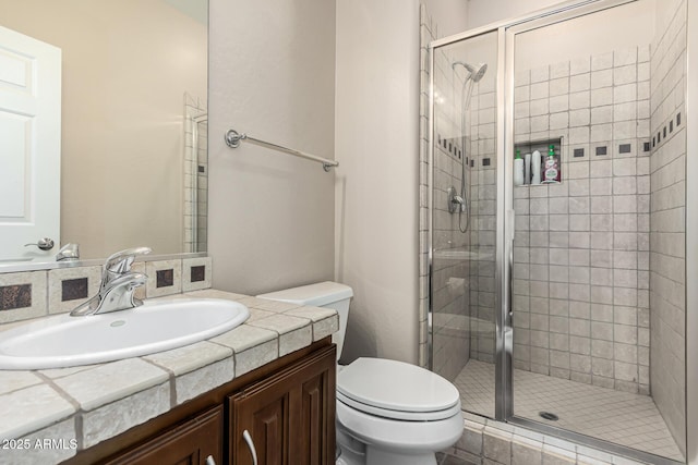 bathroom with vanity, toilet, and an enclosed shower