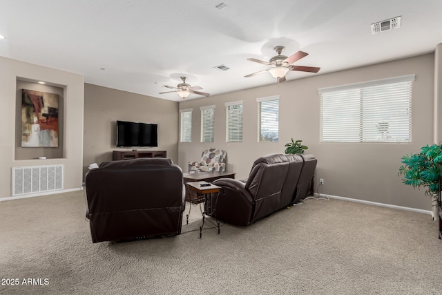 carpeted living room with ceiling fan