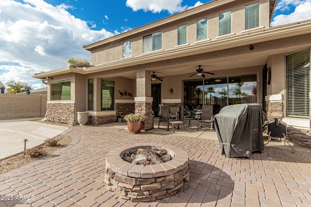 view of patio / terrace featuring grilling area, ceiling fan, and an outdoor fire pit