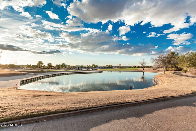 view of swimming pool featuring a water view