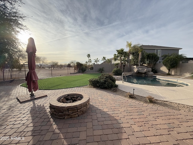 view of patio / terrace with a fenced in pool and a fire pit