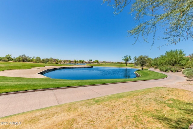 view of swimming pool with a lawn and a water view