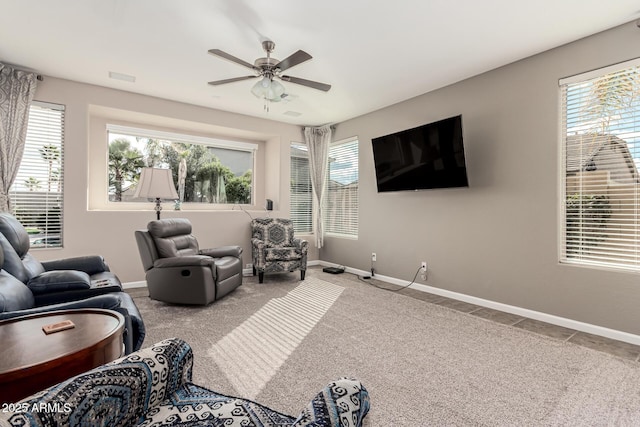 living room featuring ceiling fan and carpet