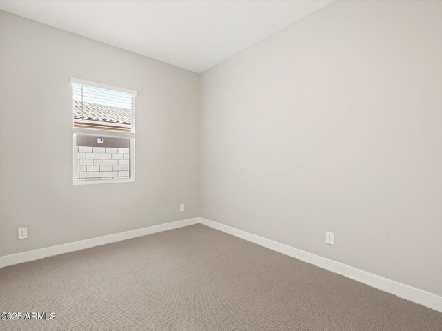 unfurnished room featuring carpet