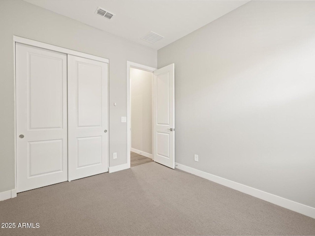 unfurnished bedroom with carpet and a closet