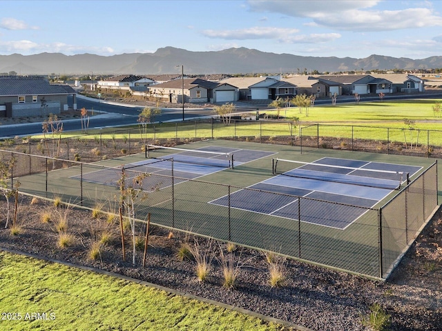 view of tennis court featuring a mountain view