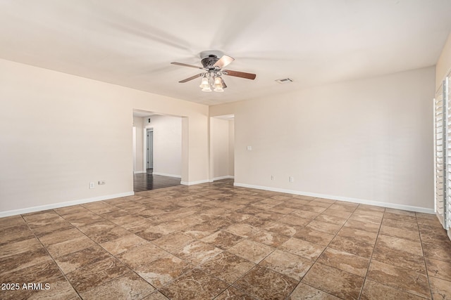 2807 N 8th Ave, Phoenix, AZ 85007 - empty room featuring a ceiling fan, stone finish flooring, and baseboards