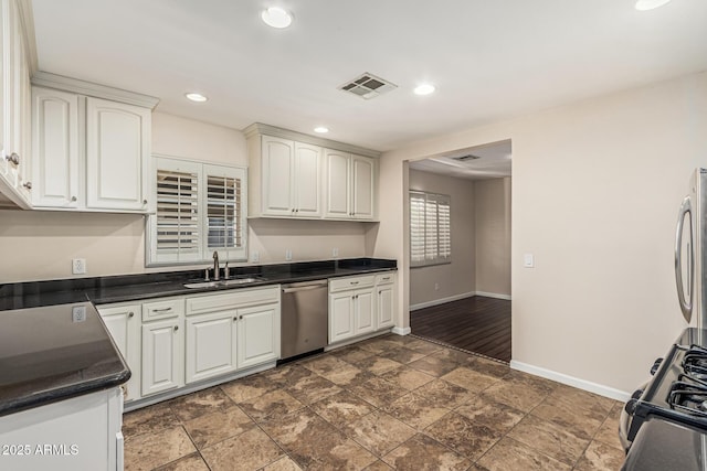 2807 N 8th Ave, Phoenix, AZ 85007 - kitchen with dishwasher, baseboards, dark countertops, a sink, and gas range