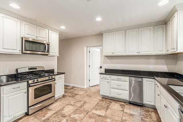 2807 N 8th Ave, Phoenix, AZ 85007 - kitchen with stainless steel appliances, dark countertops, baseboards, white cabinets, and light stone finish flooring