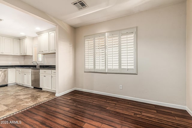 2807 N 8th Ave, Phoenix, AZ 85007 - kitchen with dark countertops, wood finished floors, baseboards, white cabinets, and recessed lighting