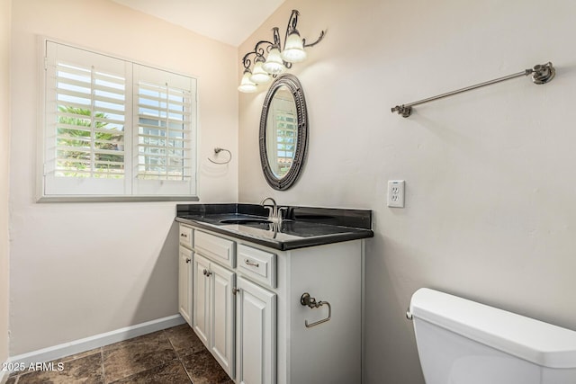 2807 N 8th Ave, Phoenix, AZ 85007 - bathroom featuring baseboards, vanity, toilet, and stone finish floors