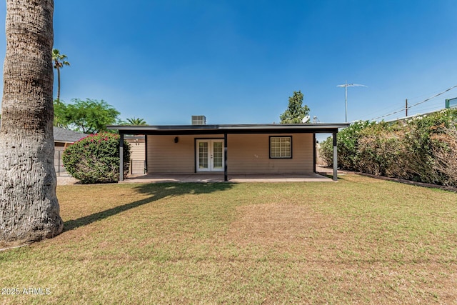 2807 N 8th Ave, Phoenix, AZ 85007 - back of property with french doors, a patio area, and a lawn