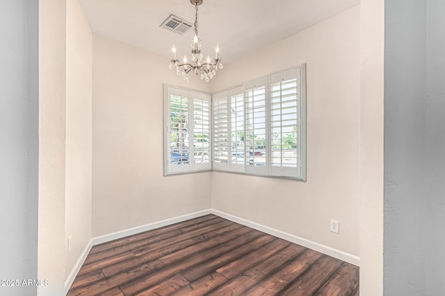 2807 N 8th Ave, Phoenix, AZ 85007 - empty room with a chandelier, baseboards, and dark wood-style flooring