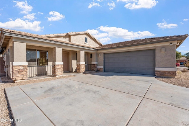 view of front of property featuring covered porch and a garage