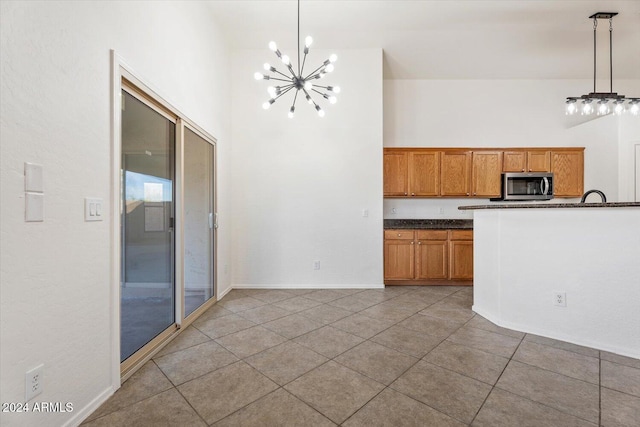 kitchen featuring tile patterned flooring, decorative light fixtures, and an inviting chandelier