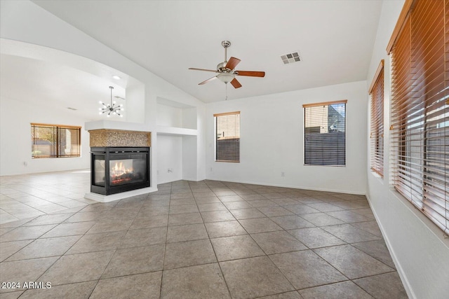 unfurnished living room with tile patterned floors, ceiling fan with notable chandelier, built in features, a multi sided fireplace, and lofted ceiling