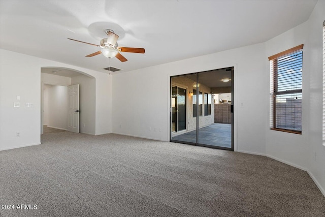 spare room featuring ceiling fan and carpet