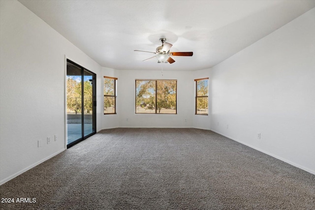 carpeted empty room featuring ceiling fan