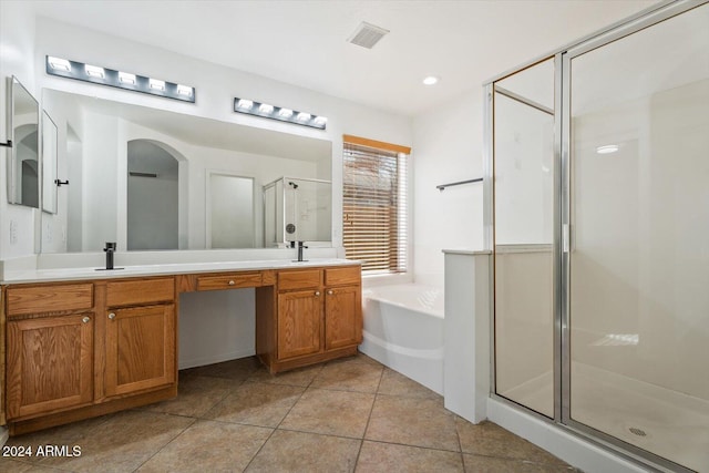 bathroom with tile patterned floors, vanity, and independent shower and bath