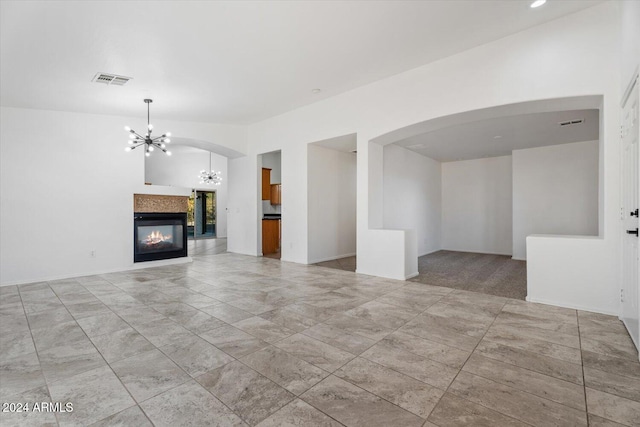 unfurnished living room with a chandelier