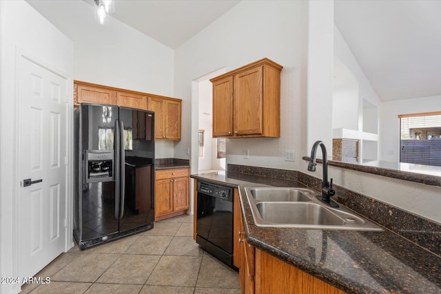 kitchen with sink, light tile patterned flooring, black appliances, and vaulted ceiling