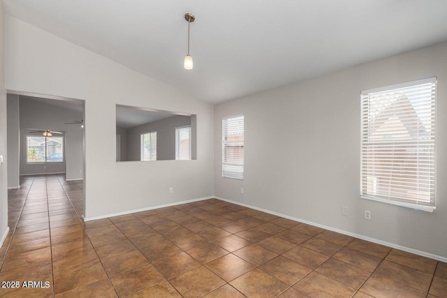 tiled spare room featuring lofted ceiling and ceiling fan