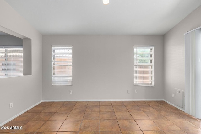 unfurnished room featuring light tile patterned floors