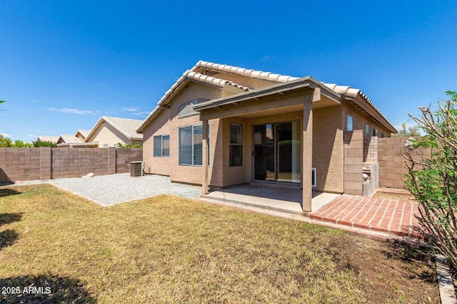 back of property featuring a patio area, cooling unit, and a yard