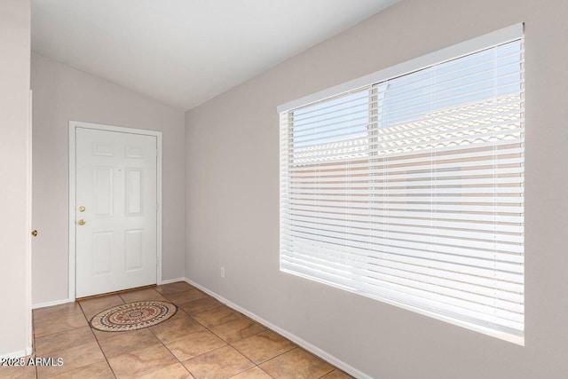 tiled foyer with vaulted ceiling