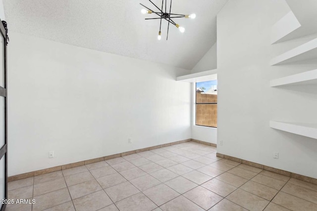 spare room featuring an inviting chandelier, light tile patterned floors, baseboards, and high vaulted ceiling