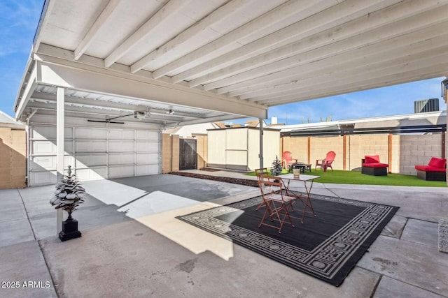 view of patio / terrace featuring outdoor dining space, an outdoor structure, a storage shed, and fence