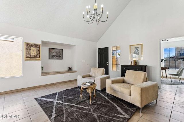 living room featuring light tile patterned floors, high vaulted ceiling, a chandelier, and baseboards