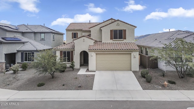 8521 S 67th Dr, Laveen, AZ 85339 - mediterranean / spanish-style home featuring stucco siding, a tiled roof, and concrete driveway