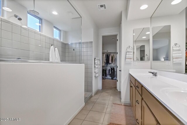8521 S 67th Dr, Laveen, AZ 85339 - bathroom featuring visible vents, double vanity, a sink, a walk in shower, and tile patterned flooring